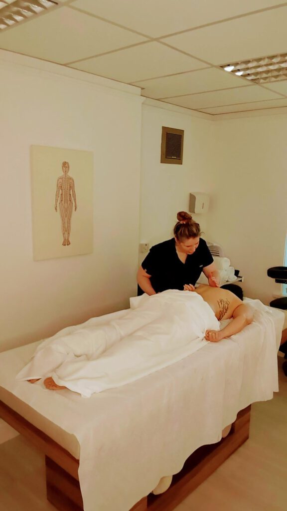 A woman having a back massage discovers how massage helps fascia. 